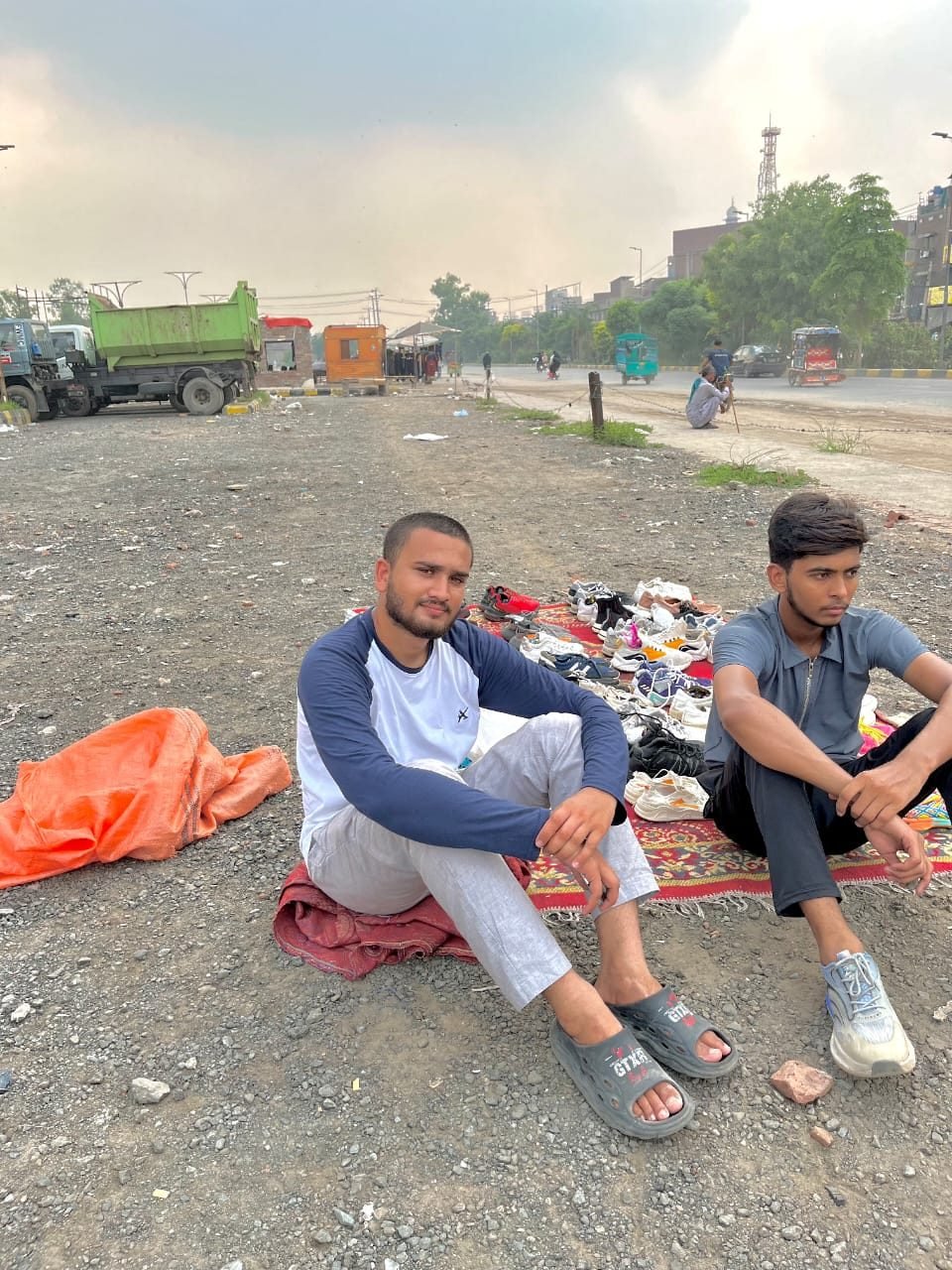 Thrifted Era's founders selling secondhand sneakers laid out on a rug on the roadside, before the store existed